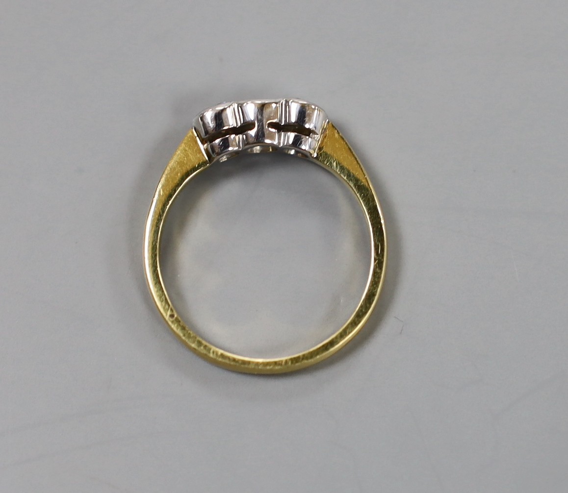 A modern 18ct gold and collet set three stone diamond set ring, size O, gross 3.8 grams